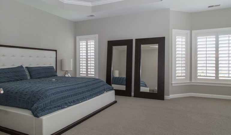 White shutters in a minimalist bedroom in Miami.